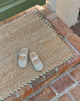 Braided Jute Doormat With Green Trim at Front Stoop