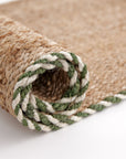 Art of the Entry Braided Jute Doormat With Green Trim Rolled Up